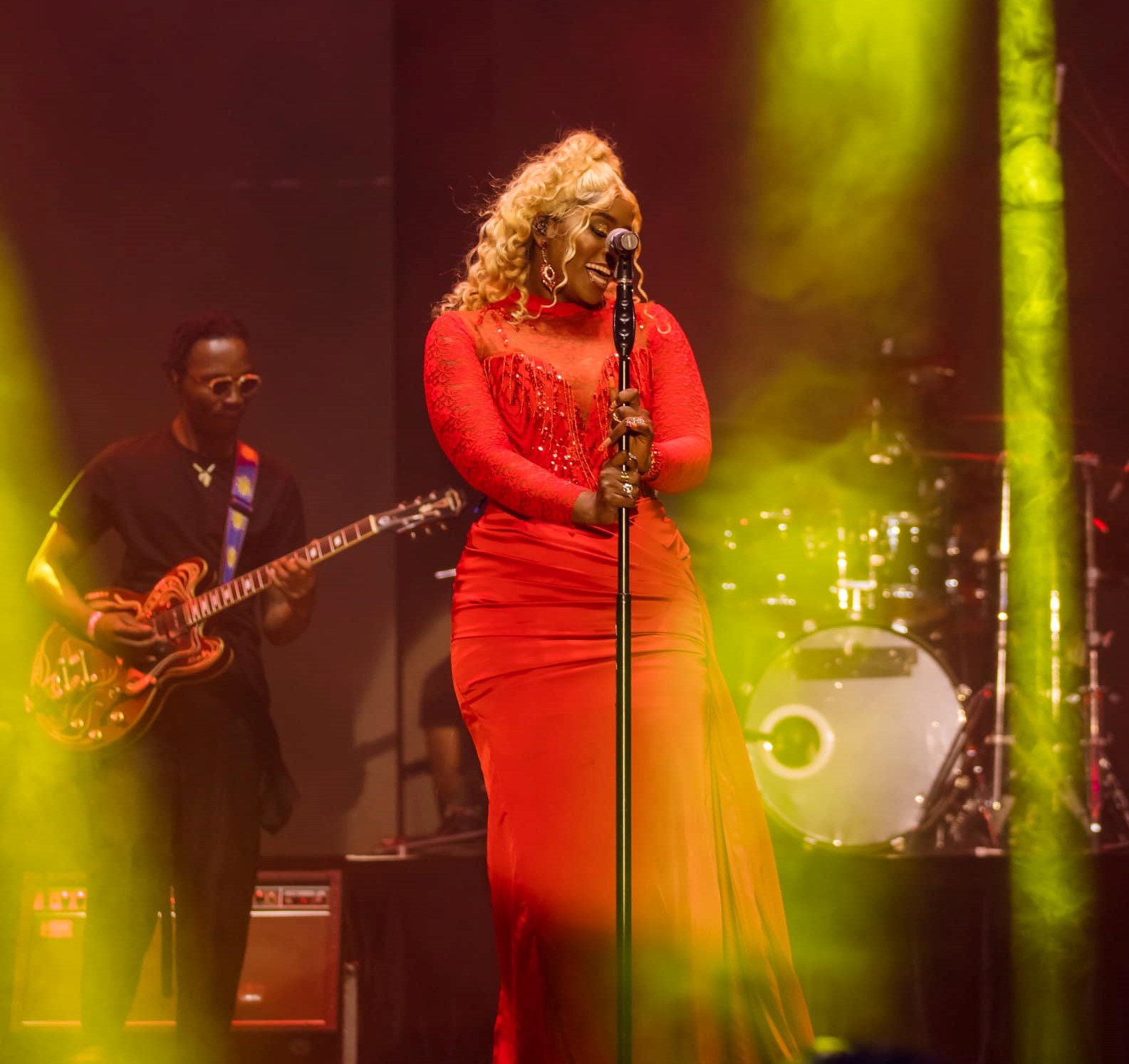 Winnie Nwagi performs in a red dress at the Fore concert